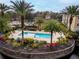 A beautiful community pool surrounded by tropical landscaping, and a community building at 4897 Cypress Woods Dr # 6314, Orlando, FL 32811
