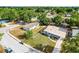 An aerial view showing the house and neighborhood with surrounding trees and greenery at 4908 Keith Pl, Orlando, FL 32808