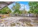 Fenced backyard featuring a mix of trees and greenery under a bright sky at 4908 Keith Pl, Orlando, FL 32808