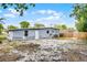 The backyard features a grey house with white trim and a small patio area at 4908 Keith Pl, Orlando, FL 32808