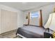 Cozy bedroom featuring wood-look floors, natural light, and a spacious double-door closet at 4908 Keith Pl, Orlando, FL 32808