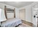 Bright bedroom with wood-look floors, comfy bed, and double door closet, offering ample storage at 4908 Keith Pl, Orlando, FL 32808