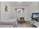 Cozy bedroom with hardwood floors, a twin bed, and a small television at 4908 Keith Pl, Orlando, FL 32808