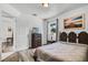 This bedroom offers wood-look floors, a comfortable bed, and tranquil views of outdoors at 4908 Keith Pl, Orlando, FL 32808
