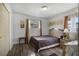 Inviting bedroom showcasing wood-look floors, a comfortable bed, and natural light at 4908 Keith Pl, Orlando, FL 32808