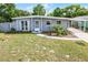 Charming single Gathering home with a carport, front yard landscaping, and a welcoming entrance at 4908 Keith Pl, Orlando, FL 32808