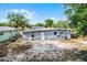 Rear exterior of the home, featuring tidy yard, AC, and neutral paint at 4908 Keith Pl, Orlando, FL 32808