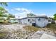 Exterior view of the home showcasing its backyard, siding, and AC unit at 4908 Keith Pl, Orlando, FL 32808
