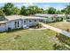 Aerial view of a cozy home with a covered parking area and well-maintained lawn at 4908 Keith Pl, Orlando, FL 32808