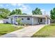 Street view of a single-story home with a carport and manicured lawn and walkway at 4908 Keith Pl, Orlando, FL 32808