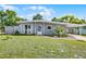 Charming single-story home with a covered carport and inviting curb appeal and fresh landscaping at 4908 Keith Pl, Orlando, FL 32808