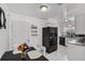 Functional kitchen featuring granite countertops, black appliances, and adjacent dining area at 4908 Keith Pl, Orlando, FL 32808