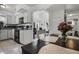 Open concept kitchen with white cabinetry, sleek countertops, and a view into the living area at 4908 Keith Pl, Orlando, FL 32808
