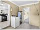 Functional laundry area with appliances, adjacent to kitchen, facilitating household chores at 4908 Keith Pl, Orlando, FL 32808
