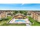 An aerial view shows the community pool area surrounded by manicured lawns and residential buildings at 505 Terrace Ridge Cir # 505, Davenport, FL 33896