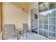 Private balcony featuring chairs, a table and an open sliding glass door to inside at 505 Terrace Ridge Cir # 505, Davenport, FL 33896