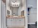 Bathroom featuring double vanity with framed mirrors, tile flooring, and closet access at 505 Terrace Ridge Cir # 505, Davenport, FL 33896