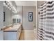 Bathroom featuring double sinks, a framed mirror, and a decorative seahorse picture at 505 Terrace Ridge Cir # 505, Davenport, FL 33896