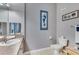 Well-lit bathroom featuring a single sink vanity with a toilet and wall decorations at 505 Terrace Ridge Cir # 505, Davenport, FL 33896