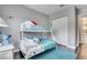 This bedroom features a bunk bed, dark wood floors, a closet, and is painted with gray walls at 505 Terrace Ridge Cir # 505, Davenport, FL 33896