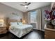 Relaxing bedroom with a ceiling fan, plush bed, and a light-filled window at 505 Terrace Ridge Cir # 505, Davenport, FL 33896