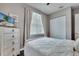 This bedroom features light walls, a ceiling fan, and a dresser at 505 Terrace Ridge Cir # 505, Davenport, FL 33896