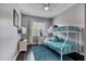 This bedroom features a bunk bed, ceiling fan, dark wood floors, and is painted with gray walls at 505 Terrace Ridge Cir # 505, Davenport, FL 33896