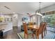 Bright dining room with views of the balcony and the outdoors, with seating for six at 505 Terrace Ridge Cir # 505, Davenport, FL 33896