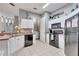 Efficient kitchen with white cabinets and black appliances, next to the laundry room at 505 Terrace Ridge Cir # 505, Davenport, FL 33896