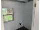 Unfinished basement with painted block walls, window, and dark tile flooring at 520 Ruffel St, Maitland, FL 32751