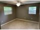 Bright bedroom featuring neutral paint, carpet, and two windows providing natural light at 520 Ruffel St, Maitland, FL 32751