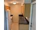 Functional kitchen with wood cabinets, white appliances, and access to the backyard at 520 Ruffel St, Maitland, FL 32751