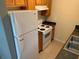 Kitchen with white appliances, wooden cabinets, and easy-to-clean countertops at 520 Ruffel St, Maitland, FL 32751