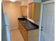 The kitchen features wooden cabinets, a stainless steel sink, and access to the backyard at 520 Ruffel St, Maitland, FL 32751