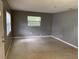 Bright living room featuring neutral carpet, fresh paint, and natural light from a window at 520 Ruffel St, Maitland, FL 32751