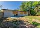 Exterior shot reveals a cozy backyard, enclosed by a wooden fence and featuring mature trees at 5201 Palisades Dr, Orlando, FL 32808