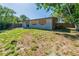 The property features a well-maintained backyard with a wooden fence and scattered mature trees at 5201 Palisades Dr, Orlando, FL 32808