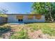 The property features a well-maintained backyard with a wooden fence and scattered mature trees at 5201 Palisades Dr, Orlando, FL 32808