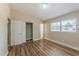 This is a bedroom featuring a closet, a window, and hardwood floors at 5201 Palisades Dr, Orlando, FL 32808