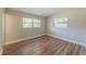 This is a bedroom featuring two large windows that let in lots of light at 5201 Palisades Dr, Orlando, FL 32808