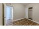 This bedroom features hardwood floors, a closet, and an open doorway at 5201 Palisades Dr, Orlando, FL 32808