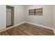 Bedroom with wood floors, window, closet, and neutral color scheme at 5201 Palisades Dr, Orlando, FL 32808