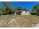 The exterior shot showing the side of a single-story house with a carport and tidy yard at 5201 Palisades Dr, Orlando, FL 32808