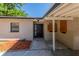 Exterior shot of a house with a black front door, neutral exterior paint, and a well-kept front yard area at 5201 Palisades Dr, Orlando, FL 32808