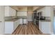 Updated kitchen with white cabinets, granite countertops, and stainless steel appliances at 5201 Palisades Dr, Orlando, FL 32808