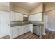 Corner view of the kitchen with stainless appliances, white cabinets, and granite countertops at 5201 Palisades Dr, Orlando, FL 32808
