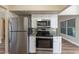 Kitchen area showcasing stainless appliances, including oven and microwave, and granite counters at 5201 Palisades Dr, Orlando, FL 32808