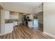 Open layout showcasing kitchen with stainless appliances that opens to bright living room at 5201 Palisades Dr, Orlando, FL 32808