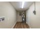 Utility room with water heater, storage hookups, and wood-style vinyl flooring at 5201 Palisades Dr, Orlando, FL 32808