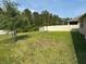 Spacious backyard featuring a well-maintained lawn and privacy fence at 5550 Bakewell Pl, St Cloud, FL 34771